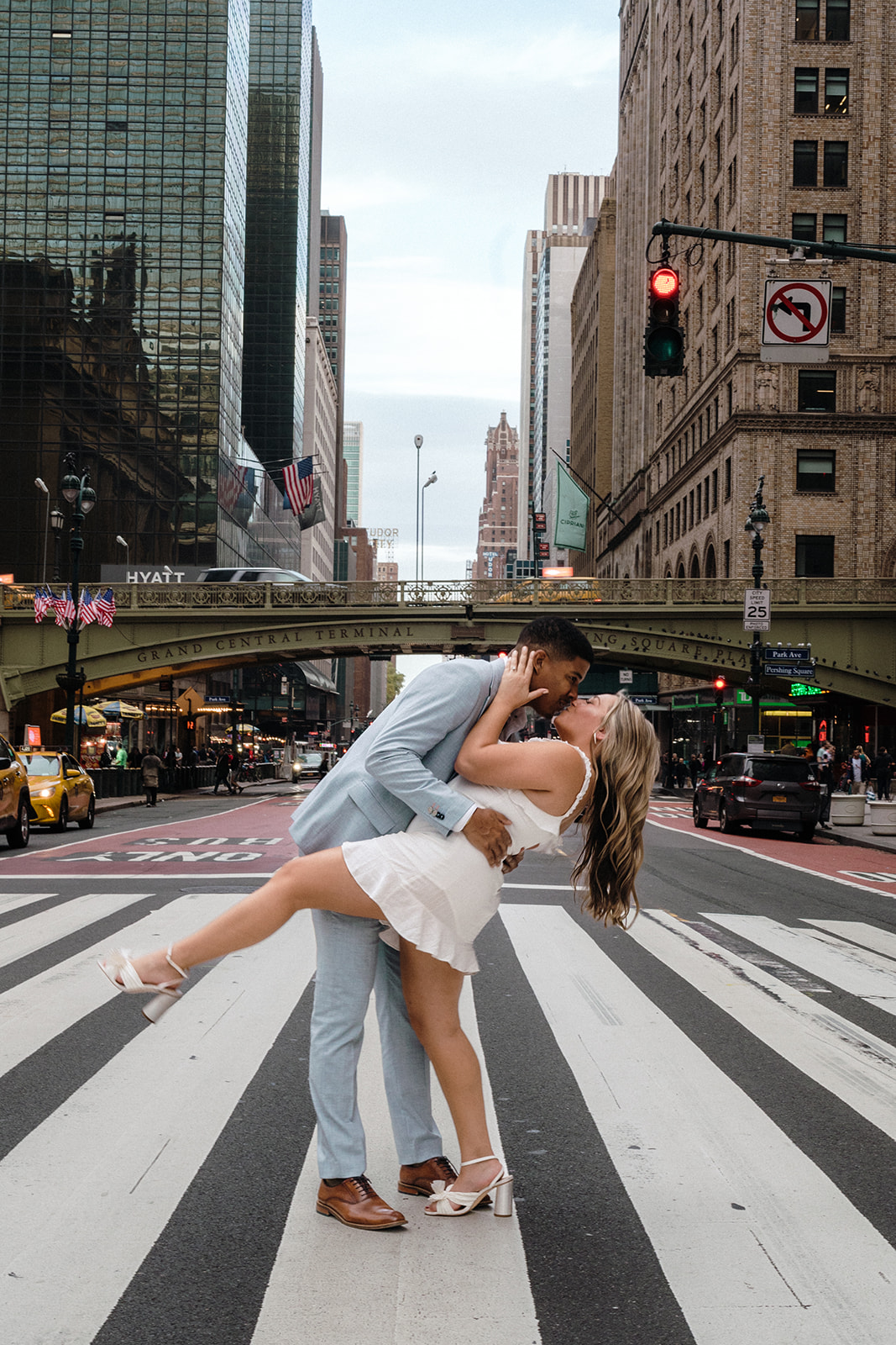 Engaged couple sharing a kiss in the middle of the road during their New York engagement shoot