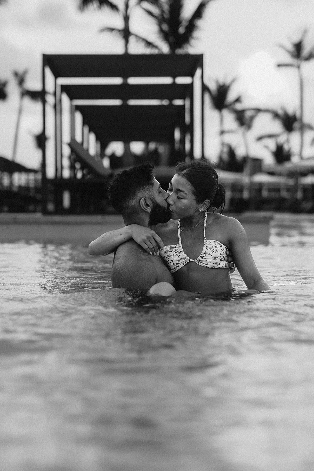 Wedding Photography and Videography Packages. Couple sharing a kiss in the pool during wedding shoot.